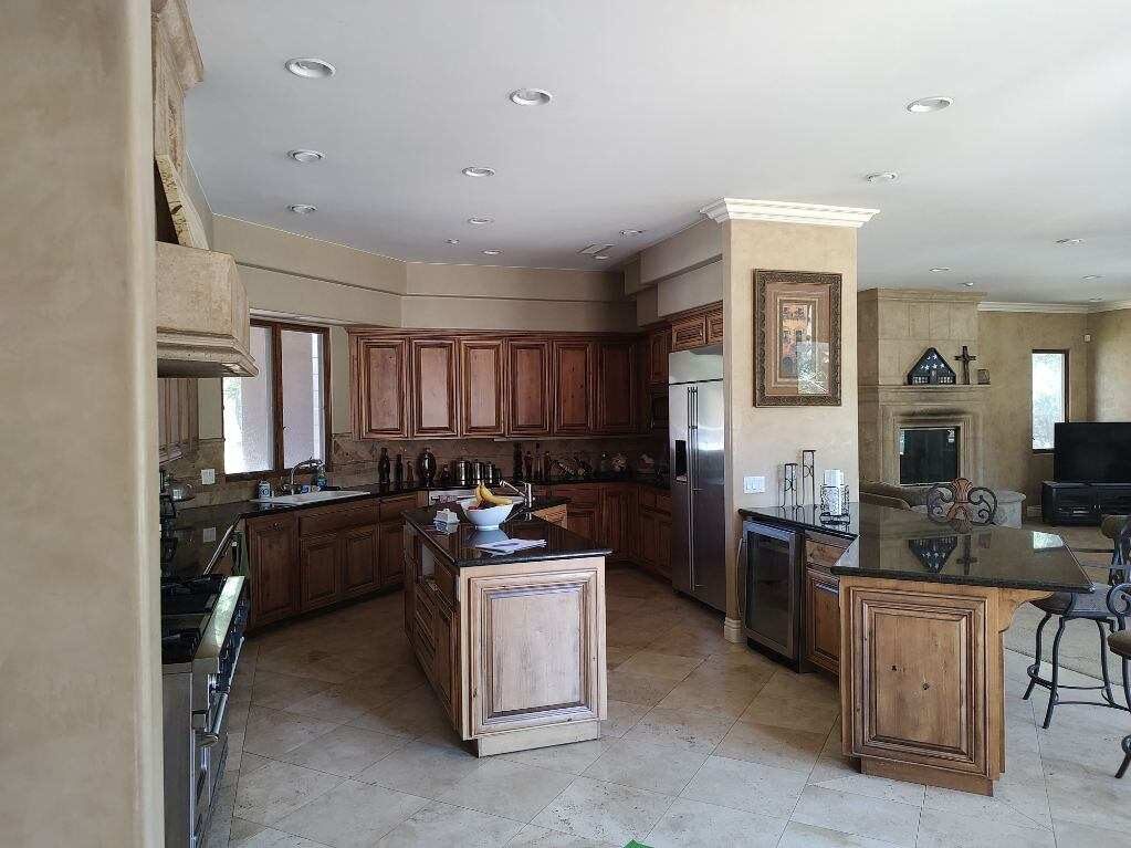 Completed kitchen and living space with custom cabinetry and finishes